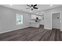 Open living room with sleek dark wood-look floors and a view of the kitchen at 1055 Mayson Turner Nw Rd, Atlanta, GA 30314
