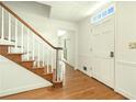 Bright entryway featuring hardwood floors, staircase, and white trim and a door with sidelight windows at 1864 Gloucester Ct, Snellville, GA 30078