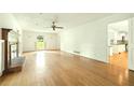 Bright living room with hardwood flooring, fireplace, and access to other areas of the home at 1864 Gloucester Ct, Snellville, GA 30078