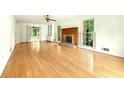 Spacious living room with hardwood floors, fireplace, white trim, and natural light at 1864 Gloucester Ct, Snellville, GA 30078