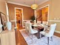 Elegant dining room featuring hardwood floors, decorative lighting, and a well-appointed table setting at 2080 Village Station Xing, Smyrna, GA 30080