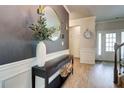 Stylish foyer with modern decor, a round mirror, and elegant lighting fixtures at 5601 Savannah River Rd, Atlanta, GA 30349