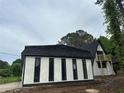 Newly renovated home with black accents, a new roof, and an A-frame design with a balcony at 6774 Collier Rd, Riverdale, GA 30296