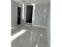 This room features light walls, marble floors, black doors, and trim with a step-up entry at 6774 Collier Rd, Riverdale, GA 30296