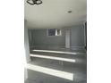 Bright living room featuring light walls, marble floors, modern lighting, and a large window at 6774 Collier Rd, Riverdale, GA 30296