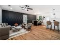 Spacious living room features an accent wall, recessed lighting, a ceiling fan and flows into the dining area at 904 Fairburn Nw Pl, Atlanta, GA 30331