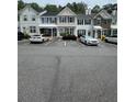 A row of townhomes with parking and landscaping offers suburban living convenience and charm at 211 Buckland Dr, Alpharetta, GA 30022