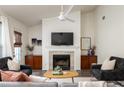 Bright living room showcasing a fireplace, neutral walls, and a modern ceiling fan at 448 Teal Ct, Roswell, GA 30076