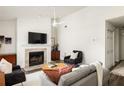 Open-concept living room with a fireplace, hardwood floors, and plenty of natural light at 448 Teal Ct, Roswell, GA 30076