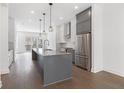 Modern kitchen boasts stainless steel appliances, a gray island, and sleek cabinetry with elegant finishes at 507 Motivation Nw Cir, Atlanta, GA 30309