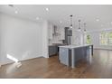 Spacious kitchen featuring stainless steel appliances, a gray island, and abundant natural light, creating an inviting atmosphere at 507 Motivation Nw Cir, Atlanta, GA 30309