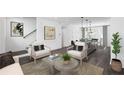 Cozy living room with neutral furniture, modern art, and an open layout, seamlessly connecting to the kitchen and dining area at 507 Motivation Nw Cir, Atlanta, GA 30309