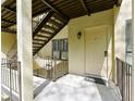 Apartment entrance features a secure entry door, staircase, and metal railing for safety at 802 Lismore Se # 2, Smyrna, GA 30080