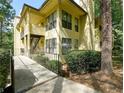 Exterior view of apartments showcasing private patios and surrounding trees at 802 Lismore Se # 2, Smyrna, GA 30080