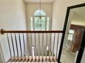 Bright stairwell with a chandelier and large window offering natural light at 3419 White Sands Way, Suwanee, GA 30214