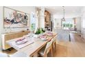 Elegant dining area with natural light, hardwood floors, and stylish decor, adjoining the kitchen at 515 Motivation Nw Cir, Atlanta, GA 30309