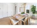 Bright dining space featuring modern chandelier, natural light, and hardwood floors at 515 Motivation Nw Cir, Atlanta, GA 30309