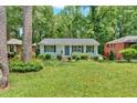 Quaint ranch-style home with a well-manicured lawn and mature trees at 2210 Polar Rock Sw Ave, Atlanta, GA 30315