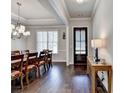Elegant dining room with hardwood floors, decorative lighting, and stylish traditional décor at 919 Olmsted Ln, Johns Creek, GA 30097