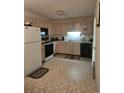 Functional kitchen features white appliances, light wood cabinets, and ample counter space at 144 Wiley Dr, Douglasville, GA 30134