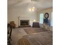 Cozy living room with fireplace, carpet, fan and natural light at 144 Wiley Dr, Douglasville, GA 30134