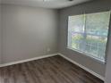 Neutral bedroom with gray walls, hardwood floors, a large window, and natural light at 3702 Gray Birch Dr, Decatur, GA 30034