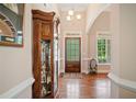 Inviting foyer with hardwood floors, a decorative cabinet, and a charming front door with sidelights at 132 Copper Hills Dr, Canton, GA 30114