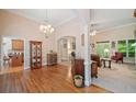 Spacious living room with hardwood floors, elegant furniture, and views into other areas of the home at 132 Copper Hills Dr, Canton, GA 30114