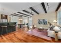 Comfortable living area with exposed beams, hardwood floors, bar seating, and natural light at 1832 Gordon Ne Mnr, Atlanta, GA 30307