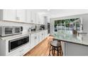 Modern kitchen with white subway tile backsplash, stainless steel appliances, hardwood floors, and granite countertops at 45 Michelle Ne Cir, Atlanta, GA 30342