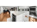Spacious kitchen with island, stainless steel appliances, white cabinets, and an open layout to the living room at 45 Michelle Ne Cir, Atlanta, GA 30342
