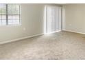 A spacious living room with neutral carpet and a large window providing abundant natural light at 475 Mount Vernon Ne Hwy # 129C, Atlanta, GA 30328