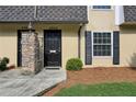 Close up of townhouse doors and brick accent columns with fresh landscaping and dark shutters at 6906 Park Ave, Atlanta, GA 30342