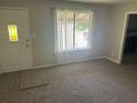 Inviting living room with plush carpeting, a bright window, and a welcoming atmosphere at 8922 Gatewood Cir, Jonesboro, GA 30238