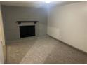 Cozy living area featuring a stone fireplace, neutral carpeting, and a warm ambiance at 8922 Gatewood Cir, Jonesboro, GA 30238