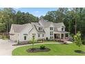 Beautiful two-story home boasting manicured lawn, lush landscaping, and a charming covered porch at 1084 Wrights Mill Rd, Canton, GA 30115