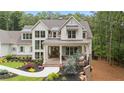 Stunning two-story home with white siding, manicured landscaping, and a welcoming front porch at 1084 Wrights Mill Rd, Canton, GA 30115