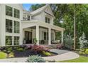 Inviting front porch with brick flooring, swing, and stylish columns enhancing curb appeal at 1084 Wrights Mill Rd, Canton, GA 30115