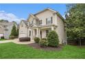 Charming home with manicured lawn and landscaping highlighting the side entrance at 308 Evening Rain Crst, Canton, GA 30114