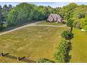 Expansive lawn with a charming brick home in the background at 5360 Franklin Goldmine Rd, Cumming, GA 30028