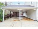 Spacious carport featuring a wooden privacy screen and an adjacent deck at 970 Winding Creek Trl, Sandy Springs, GA 30328