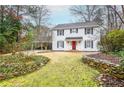 Inviting two-story home featuring classic white siding, red door, and manicured front yard at 970 Winding Creek Trl, Sandy Springs, GA 30328