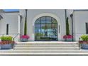 Elegant entrance features a striking arched glass door, stone steps, and decorative planters at 2305 Braselton Hwy, Buford, GA 30519