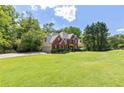 Beautiful two-story home showcasing its well-manicured lawn and mature trees at 3310 Chartwell Blvd, Suwanee, GA 30024