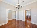 Spacious dining room with hardwood floors, neutral paint and chandelier at 3930 Charleston Market St # 221, Suwanee, GA 30024