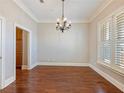 Bright dining room with hardwood floors, neutral paint and shuttered windows at 3930 Charleston Market St # 221, Suwanee, GA 30024