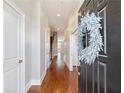 Inviting entrance hallway featuring hardwood floors and neutral paint at 3930 Charleston Market St # 221, Suwanee, GA 30024