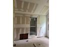 Bright bedroom with window needing renovation with drywall, exposed wood, and paint at 1946 Montrose Dr, Atlanta, GA 30344