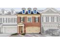 Charming brick townhome featuring dormer windows and attached two-car garage at 2260 Edgartown Se Ln # 1, Smyrna, GA 30080