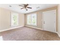 Bright bedroom with neutral walls, ceiling fan, and exterior access door at 2497 Lakewood Sw Ave, Atlanta, GA 30315